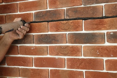 Photo of Professional builder using tiling fugue for grouting, closeup