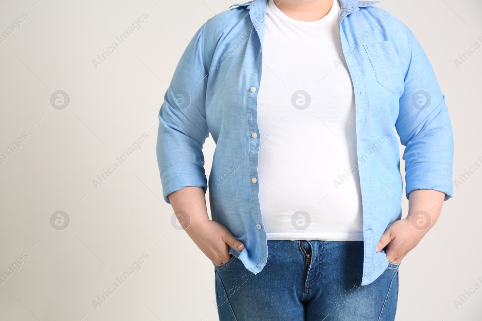 Photo of Overweight woman on light background