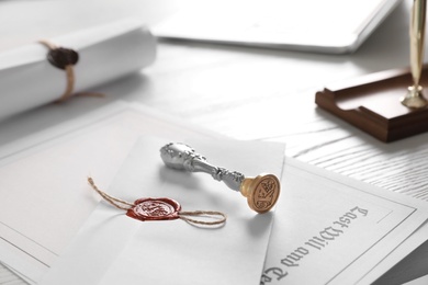 Photo of Vintage notary stamp and documents on desk, closeup