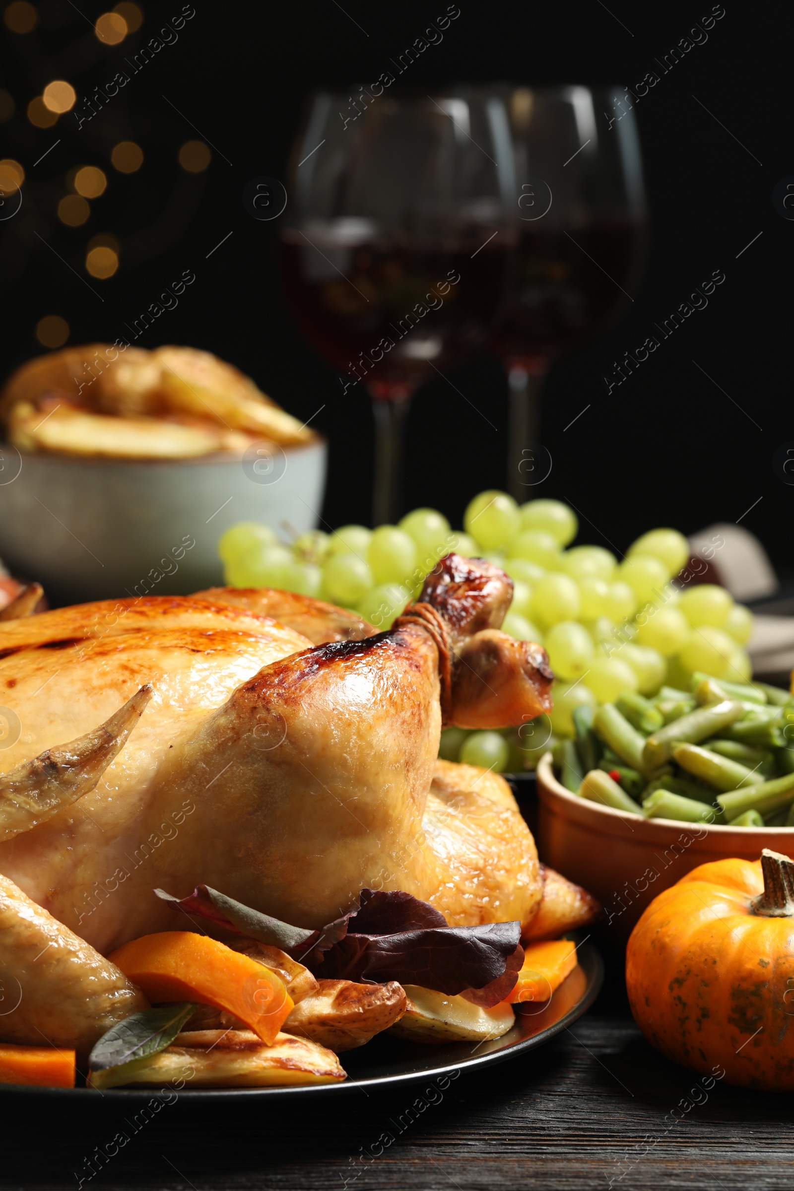 Photo of Traditional Thanksgiving day feast with delicious cooked turkey and other seasonal dishes served on table, closeup