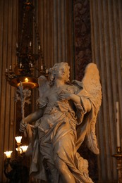 Rome, Italy - February 3, 2024: Statue of angel at altar of St Aloysius Gonzaga in Church of St. Ignatius