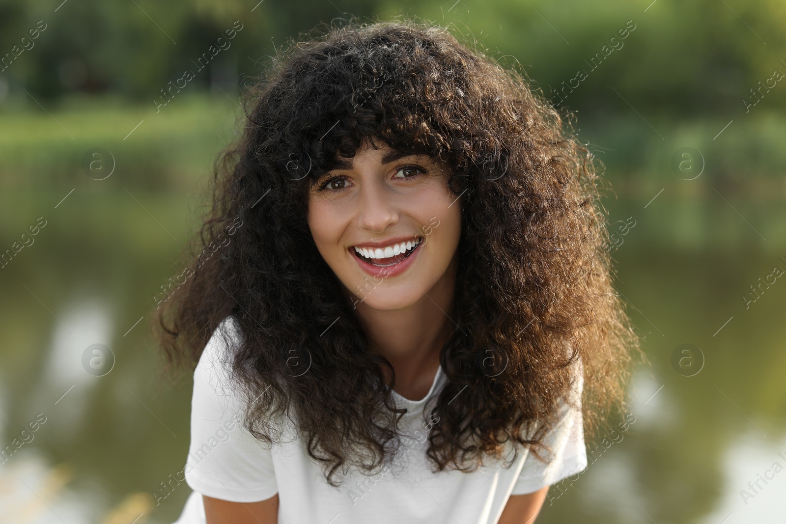 Photo of Portrait of beautiful woman posing on blurred background. Attractive lady smiling and looking into camera