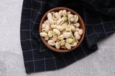 Sprouted kidney beans in bowl on light grey table, top view