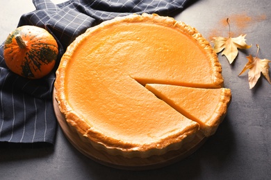 Fresh delicious homemade pumpkin pie on gray table