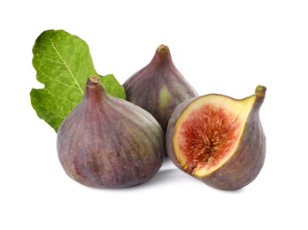 Photo of Tasty whole and cut figs with green leaf isolated on white