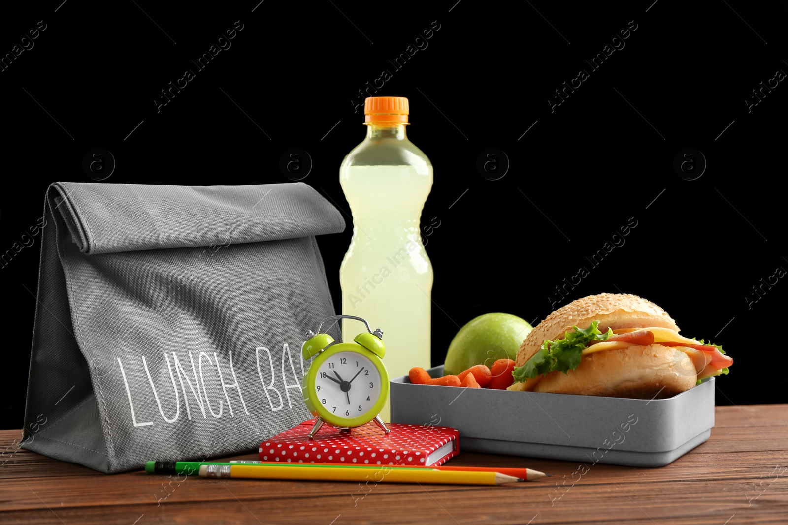 Photo of Lunch box with appetizing food and bag on table