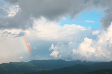 Photo of Picturesque view of sky with clouds and rainbow