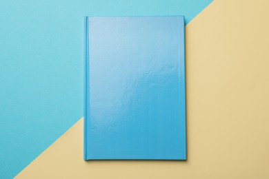 New light blue planner on color background, top view