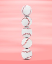 Stack of baseball balls on pink background