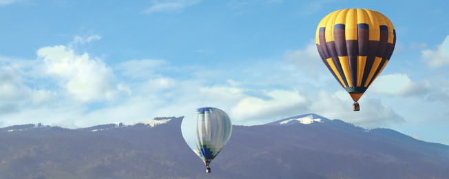 Image of Hot air balloons near mountains. Banner design 