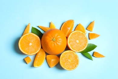 Flat lay composition with ripe oranges on color background