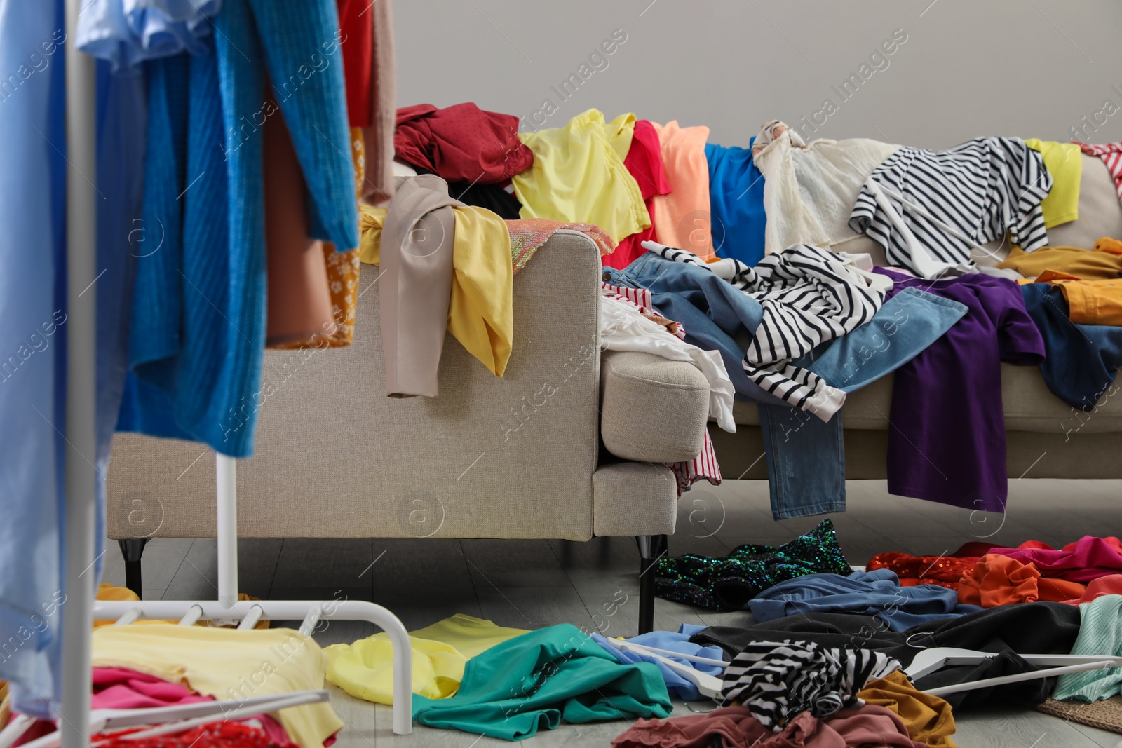 Photo of Mess of clothes all over room. Fast fashion