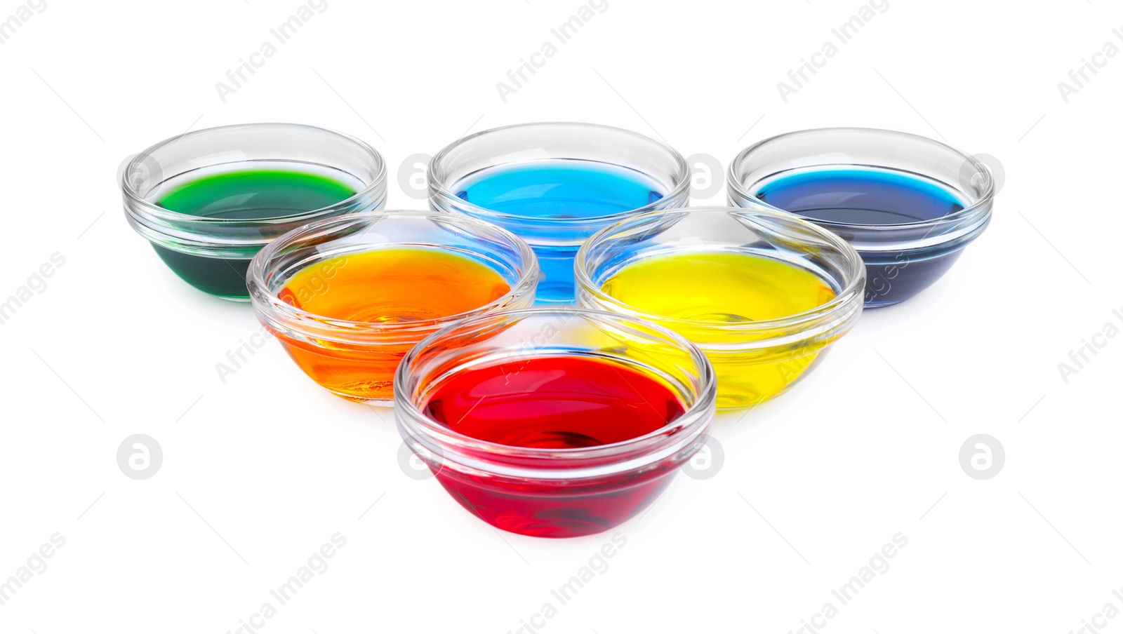 Photo of Glass bowls with different food coloring on white background