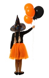 Photo of Cute little girl with balloons wearing Halloween costume on white background