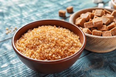 Photo of Bowl with  brown sugar on wooden table