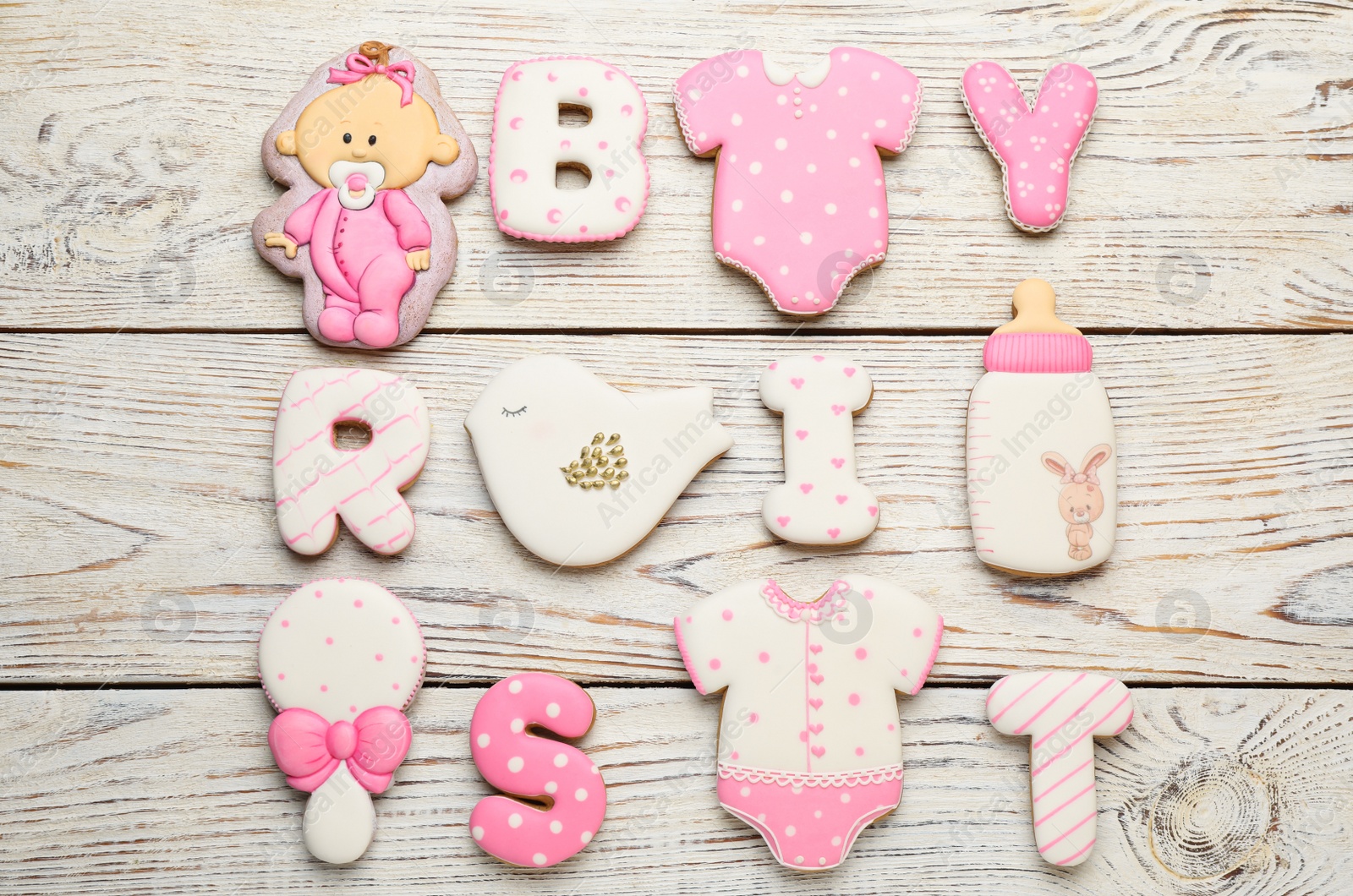 Photo of Set of baby shower cookies on white wooden table, flat lay