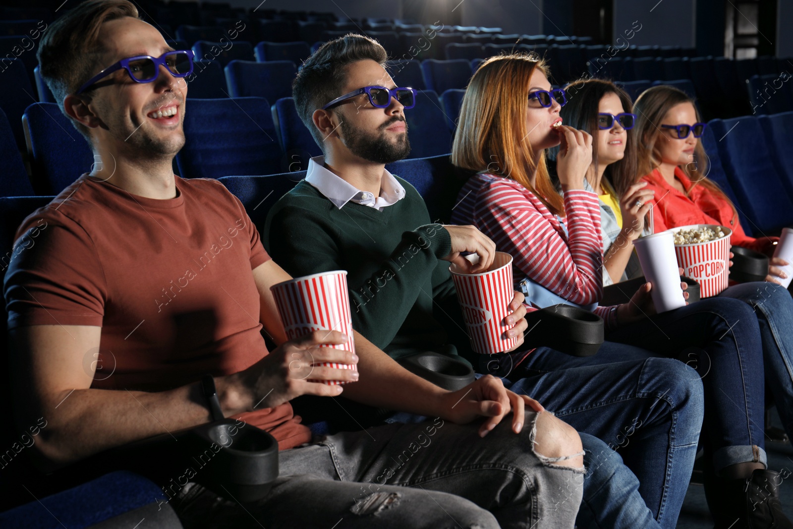 Photo of Young people watching movie in cinema theatre