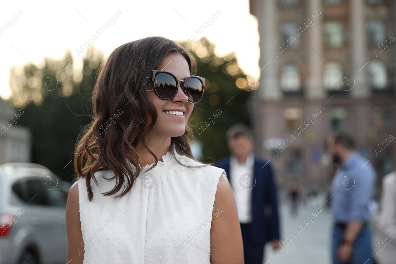 Photo of Young woman walking on modern city street