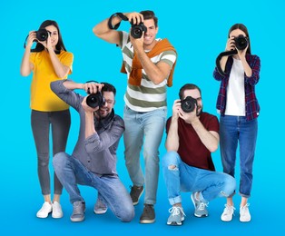 Group of professional photographers with cameras on turquoise background