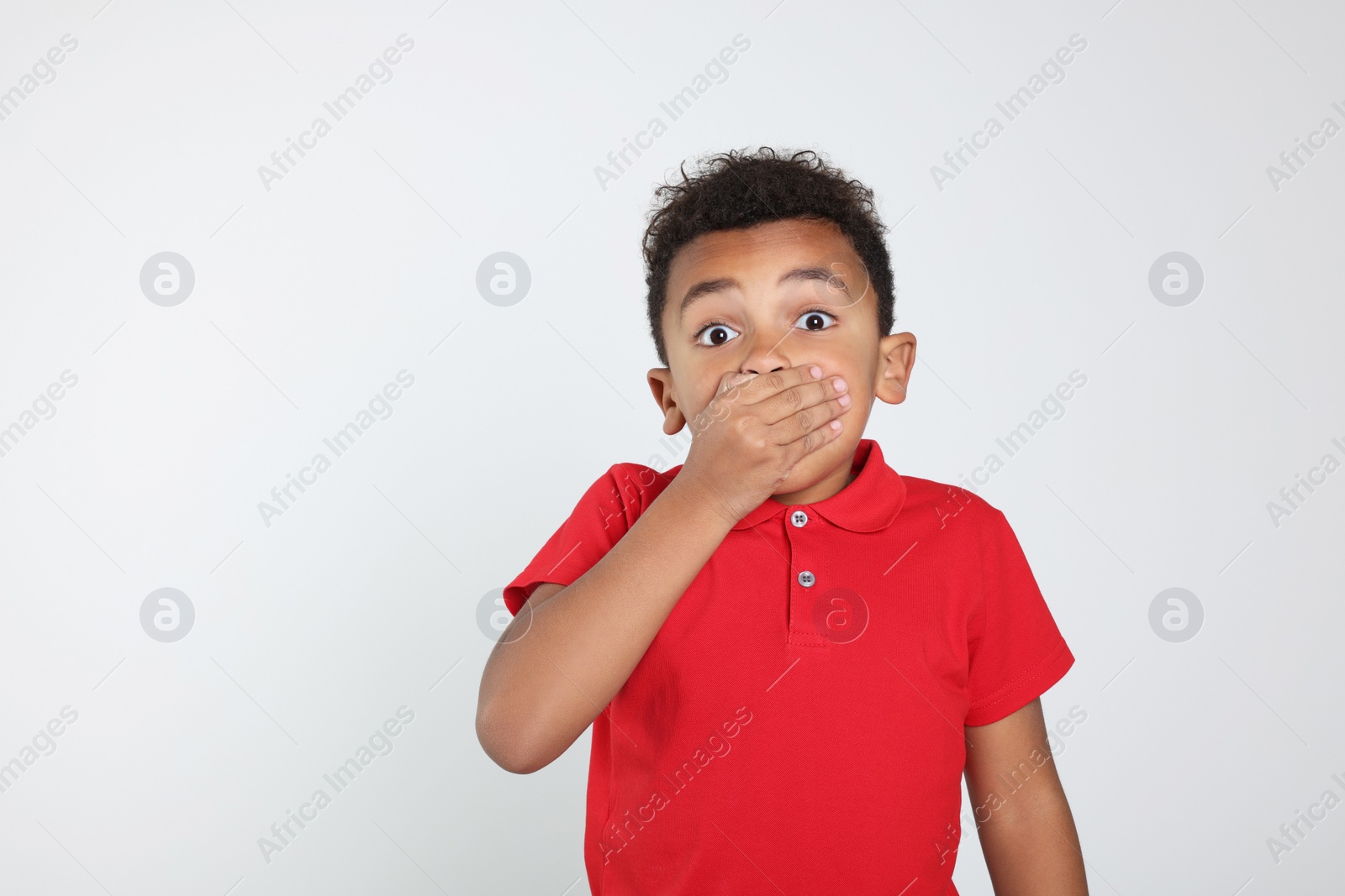 Photo of Emotional African-American boy on light grey background. Space for text