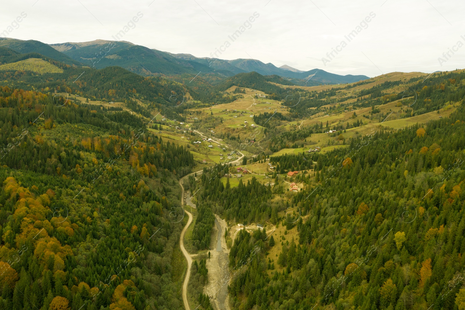 Image of Aerial view of beautiful mountain forest with road on autumn day