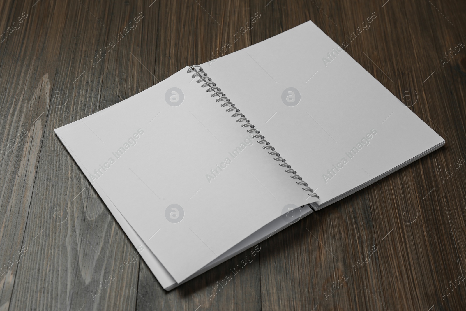 Photo of Blank paper brochure on wooden table. Mockup for design