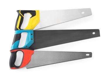 Saws with colorful handles isolated on white, top view