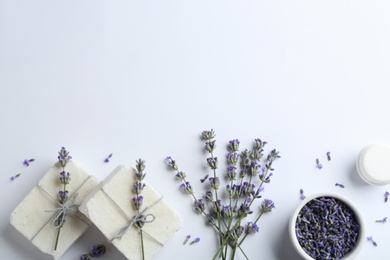 Photo of Composition with hand made soap bars and lavender flowers on white background, top view