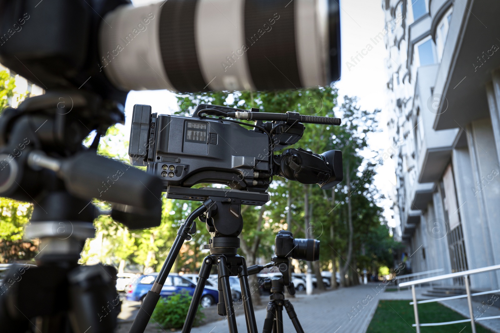 Photo of Modern video cameras outdoors. Professional media equipment