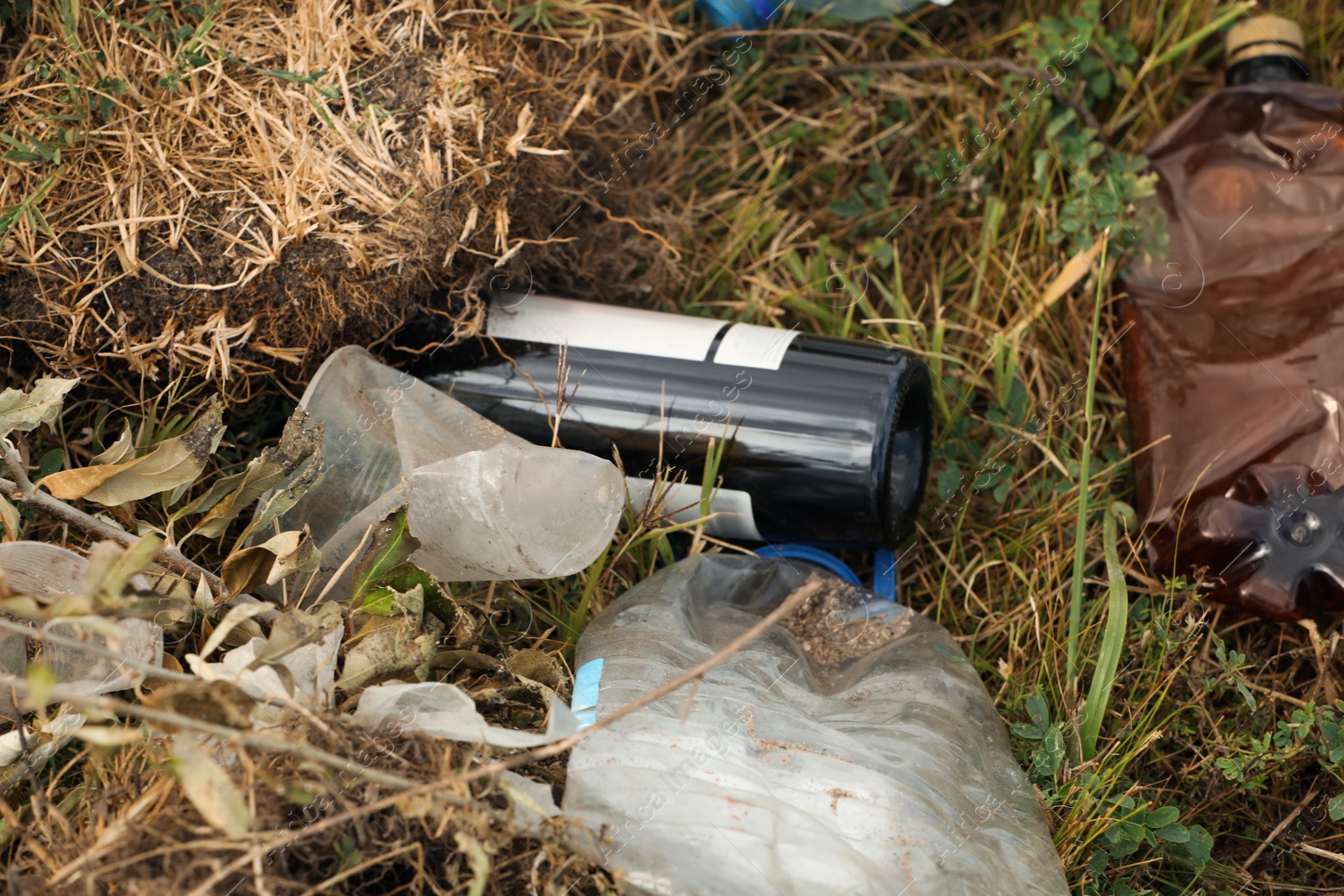 Photo of Garbage scattered on grass. Environment pollution problem