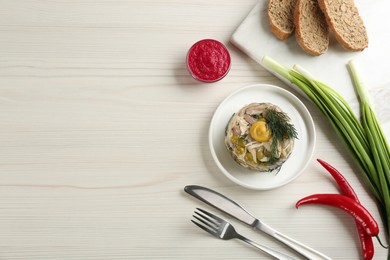 Photo of Delicious aspic with meat served on white wooden table, flat lay. Space for text