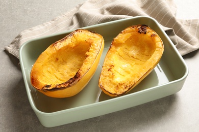 Photo of Cooked spaghetti squash in baking dish on table