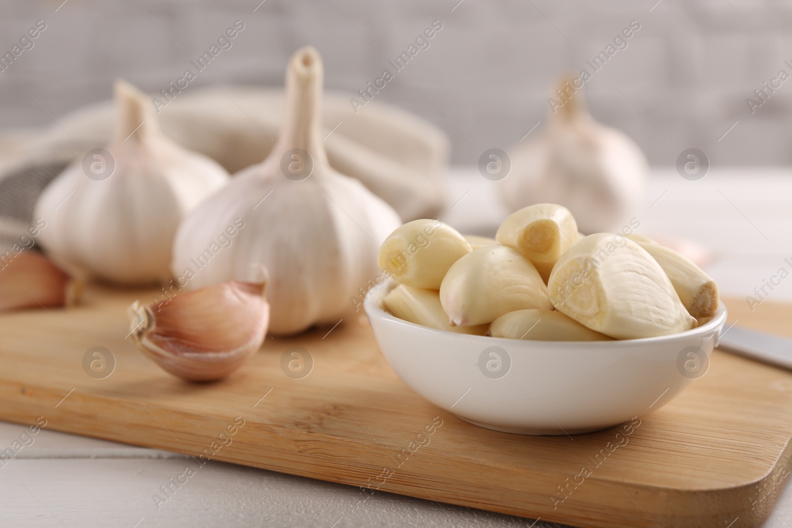 Photo of Fresh garlic on white wooden table, closeup