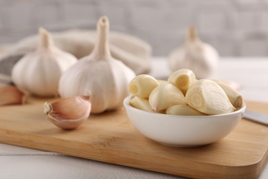 Photo of Fresh garlic on white wooden table, closeup