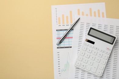 Photo of Accounting documents, calculator and pen on beige background, top view. Space for text