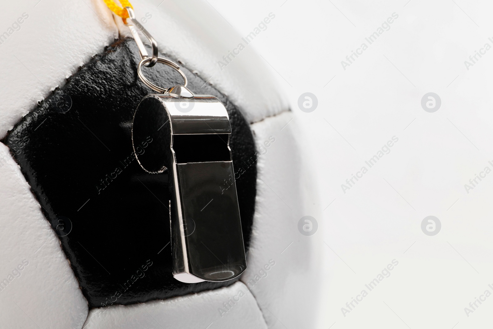 Photo of Football referee equipment. Soccer ball and whistle on white background