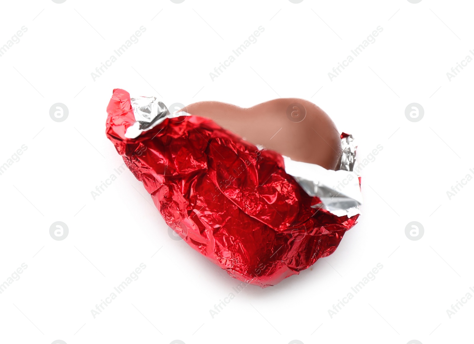 Photo of Heart shaped chocolate candy in red foil on white background, top view