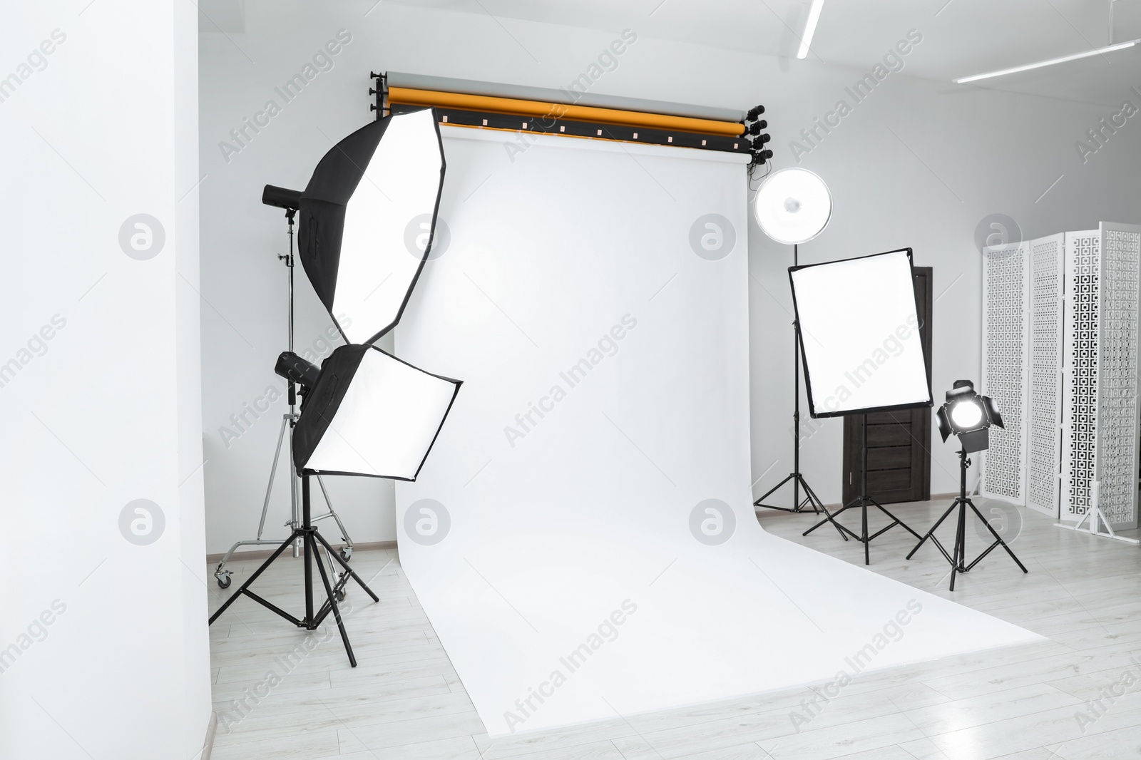 Photo of Interior of modern photo studio with professional lighting equipment