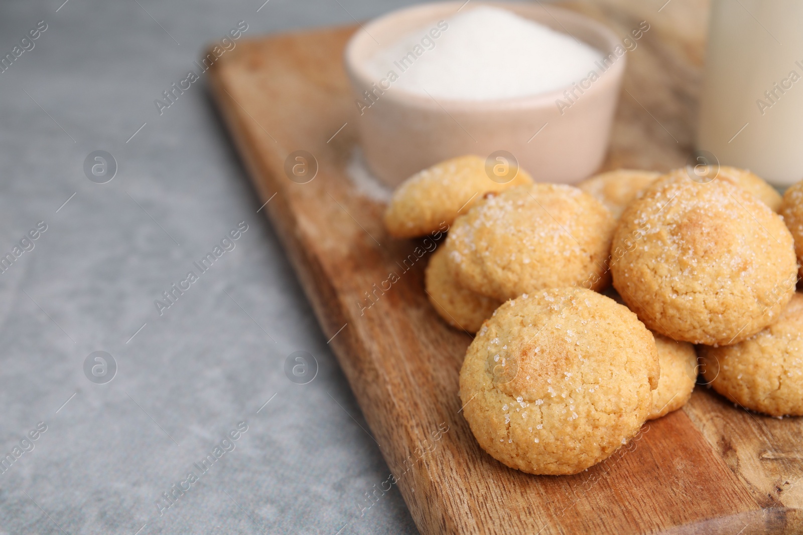 Photo of Tasty fresh sugar cookies on grey table, closeup. Space for text