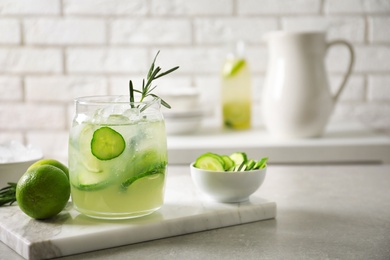 Photo of Jar with fresh lemonade and ingredients on table