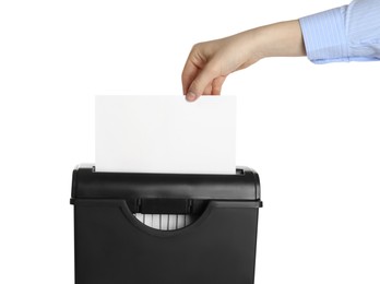 Photo of Woman destroying sheet of paper with shredder on white background, closeup