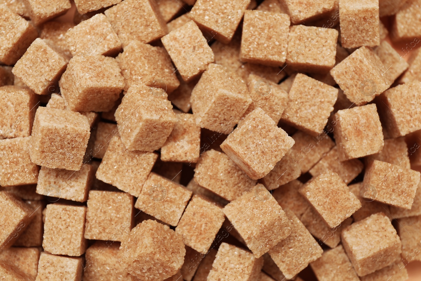 Photo of Brown sugar cubes as background, top view