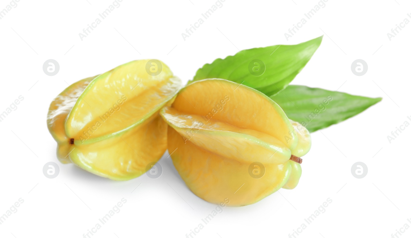 Photo of Ripe carambolas with green leaves on white background