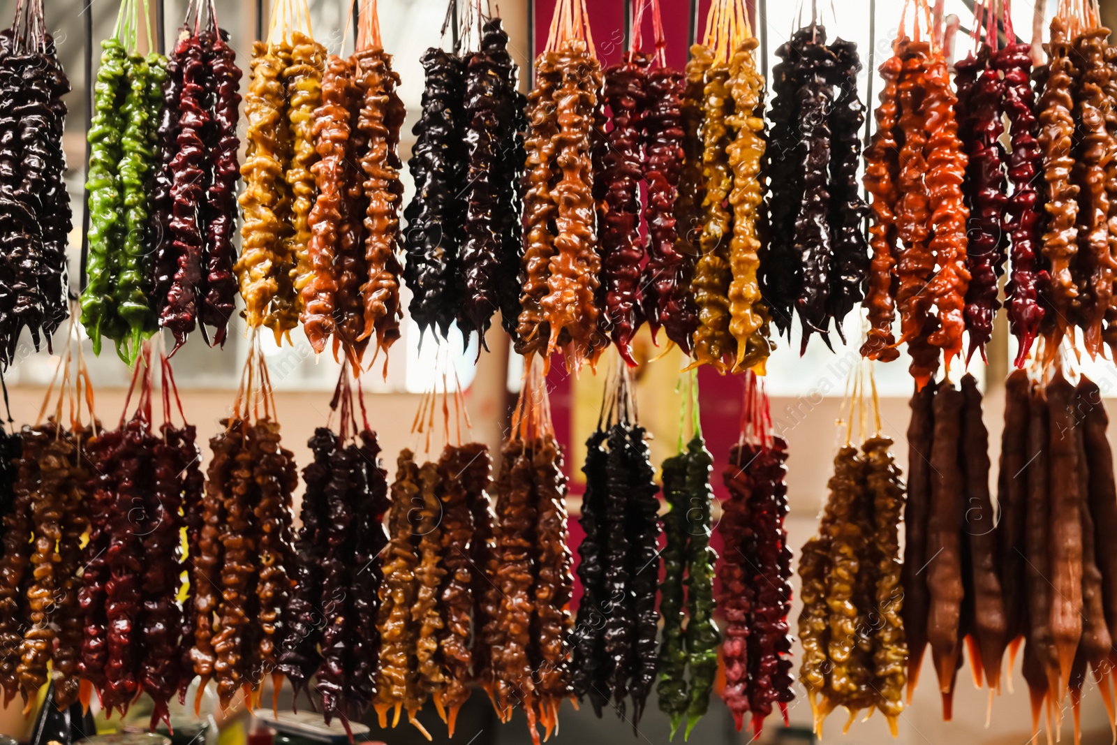 Photo of Bunches of different delicious churchkhelas at market