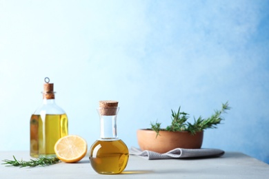 Photo of Composition with fresh rosemary oil on table