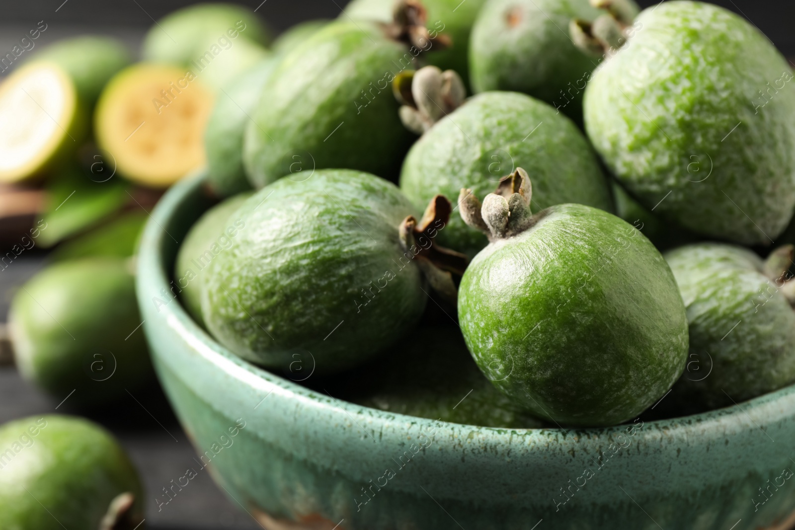 Photo of Fresh green feijoa fruits in bowl, closeup