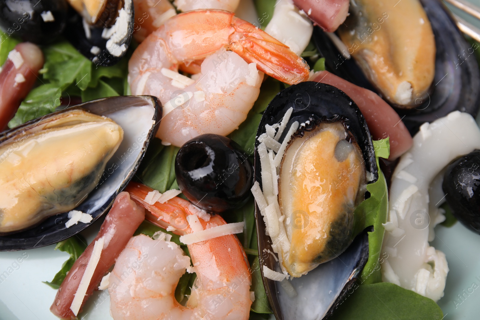 Photo of Plate of delicious salad with seafood, closeup view