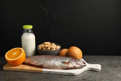 Photo of Allergenic food. Different fresh products on gray table against dark background, space for text