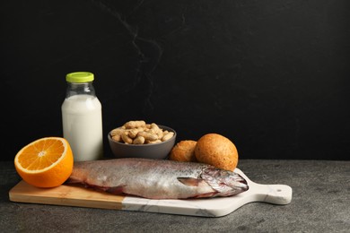 Allergenic food. Different fresh products on gray table against dark background, space for text