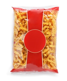 Uncooked fusilli pasta in plastic bag on white background, top view